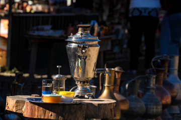 Fototapeta na wymiar Traditional Russian samovar and tea accessories outdoors