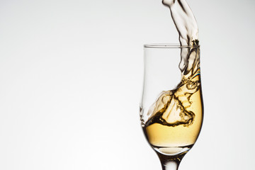 One elegant glass with sparkling champagne with splash