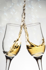 Two elegant glasses with sparkling champagne with splash