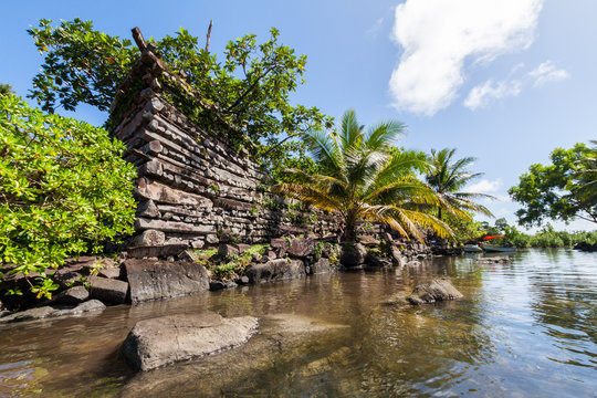 A channel and town walls in Nan Madol - prehistoric ruined stone city built of basalt slabs. Ancient walls were built on coral artificial islands in the lagoon of Pohnpei, Micronesia, Oceania