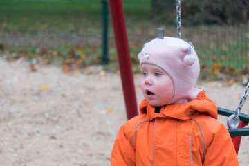 Child's emotion on the playground in autumn day