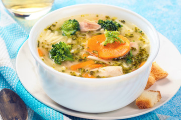 Italian vegetable soup with broccoli carrots and noodles in chicken broth