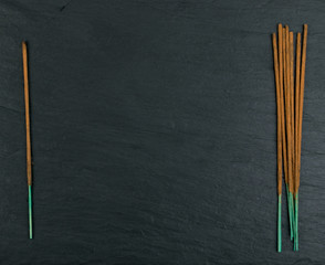 New incense aroma sticks on black background top view