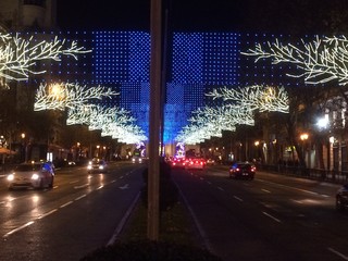 Illuminted street with Christmas decorative vibrant lights in Madrid Spain represents festive mood.