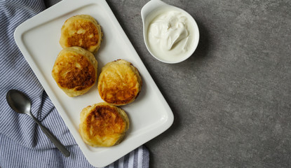 cottage cheese pancakes, tasty healthy breakfast, top view, grey stone background