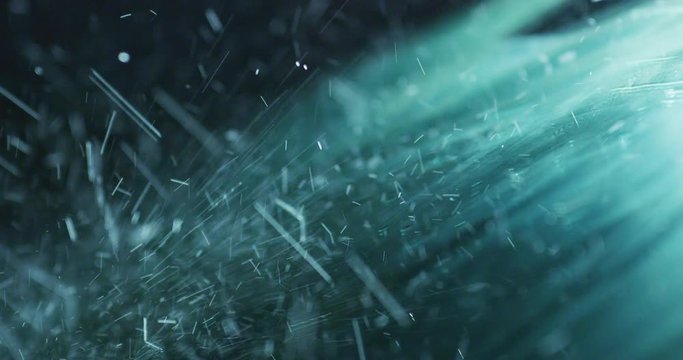 Super close up of a carglass while it’s raining, the wipers are taking off the water from it. Concept: thunderstorm, car, weather. Shot on Red Camera 8K
