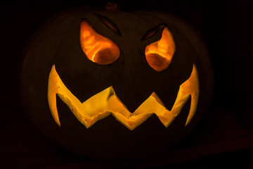 Glowing Jack-o'-lantern pumpkin in the dark for Halloween
