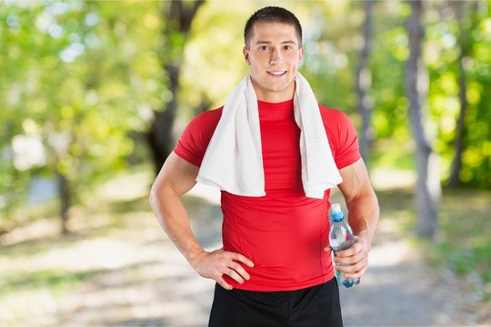 Handsome athletic man with towel on neck