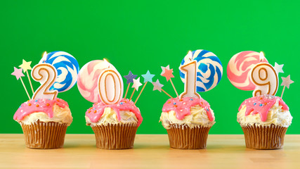 2019 Happy New Year's candyland lollipop drip cupcakes on green chroma key background.