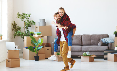 happy young married couple moves to new apartment
