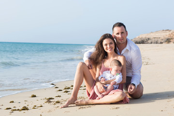 Fototapeta premium Good looking , young family is spending nice time at the beach.