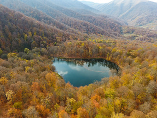 Drone flight over a hidden Gosh lake in the Armenian autumn forests