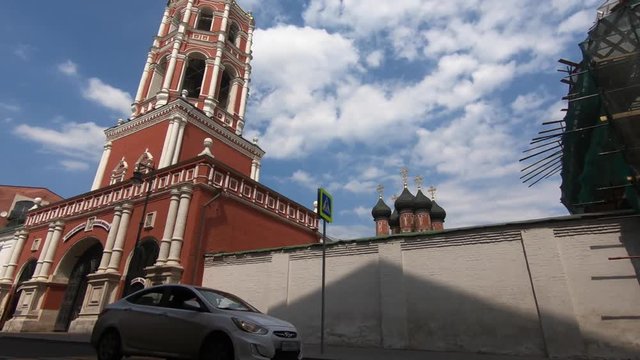 walking view of a street in Moscow, mosque and catholic church in the background