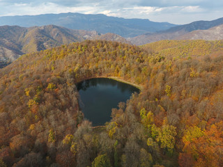 Drone flight over a hidden Gosh lake in the Armenian autumn forests