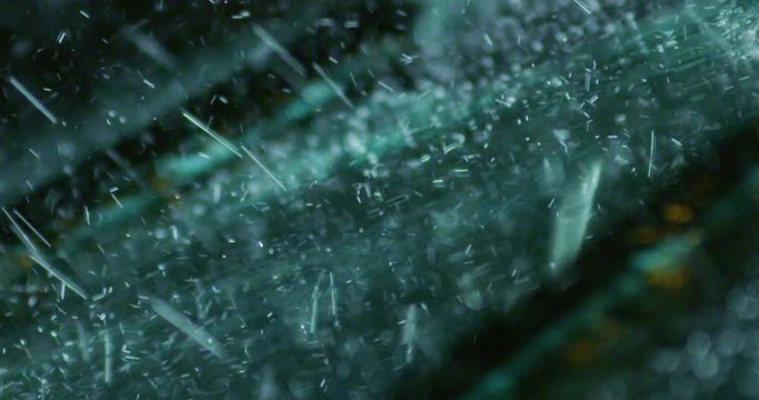 Super close up of a carglass while it&rsquo;s raining, the wipers are taking off the water from it. Concept: thunderstorm, car, weather. Shot on Red Camera 8K