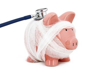 Piggy bank wrapped in gauze with a stethoscope - financial check