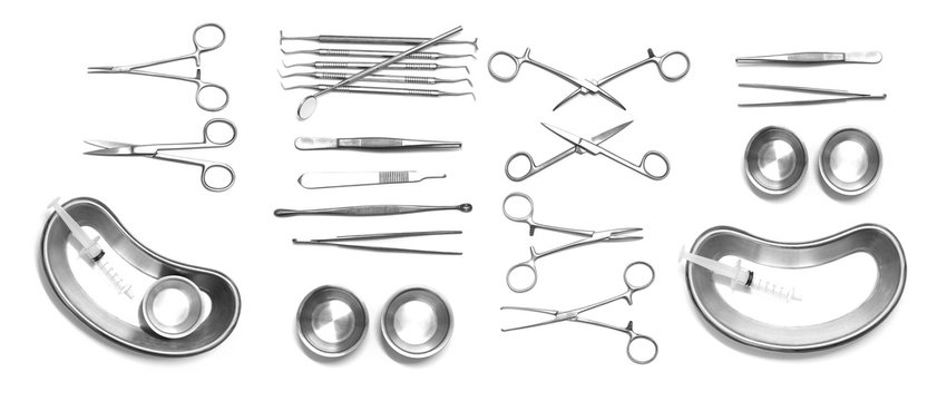 Collection of surgical instruments and tools including on white background
