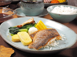 A set menu fried fish  with vegetables, rice and soup .