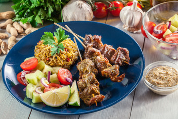 Traditional pork satay with peanut sauce and vegetables
