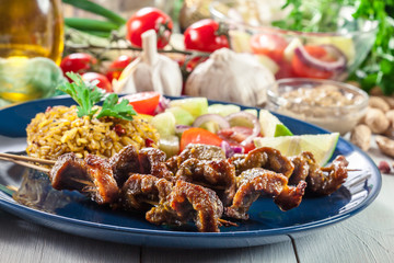 Traditional pork satay with peanut sauce and vegetables