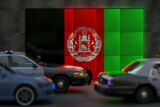 Bright digital display Afghanistan flag in city as cars drive past