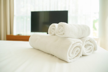 white fluffy towels on bed for hotel customer
