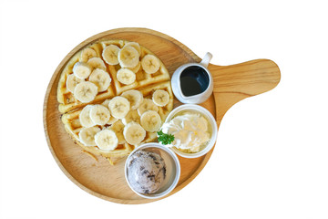 banana on waffle with ice cream and wipping cream on wood plate isolated on white background and clipping path
