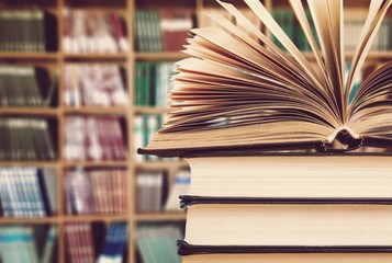 Old stacked books on blurred background