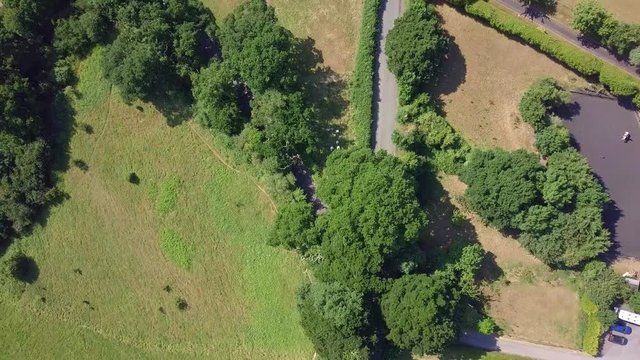 Aerial Top View, flying over countryside roads with driving cars, Devon, England