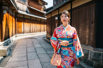 Fototapeta na wymiar Japanese girl walking in the old street