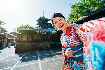 traveler taking selfie with pagoda in Kyoto