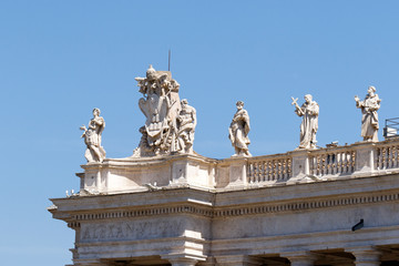 Naklejka premium Bernini's sculptures on top of the colonnade in Piazza San Pietro (St. Peter's Square) in the Vatican City