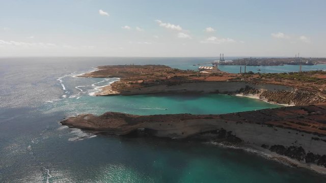 Aerial drone video from eastern Malta, Marsaxlokk area, Il-Hofra l-Kbira bay.