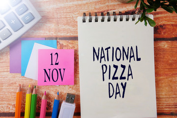 INTERNATIONAL EVENT CALENDAR CONCEPTUAL : NATIONAL PIZZA DAY  , 12 NOV with background of office stationeries.