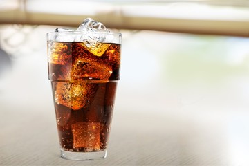 Glass of cola with ice cubes isolated on white background