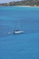 Obraz premium Sailboat and Dinghy in Paradise