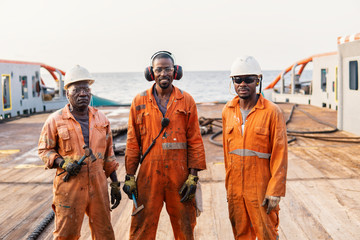 Seamen crew AB or Bosun on deck of offshore vessel or ship , wearing PPE personal protective...