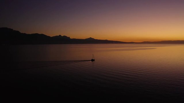 Clockwise slow orbit around sailboat on Lake L&radic;&copy;man with beautiful sunset colors
In front of Cully, Lavaux - Switzerland. The Alps in the background