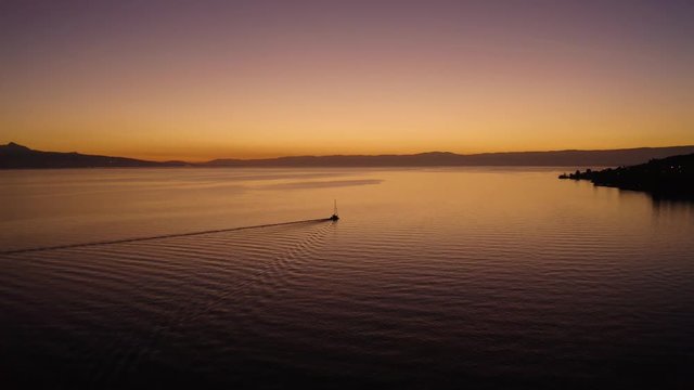 Orbiting sailboat on Lake L&radic;&copy;man with beautiful sunset colors
In front of Cully, Lavaux - Switzerland, the Alps in the background