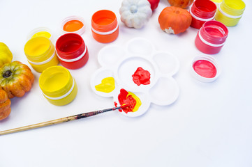 Paint gouache and plastic pumpkin. Halloween holiday