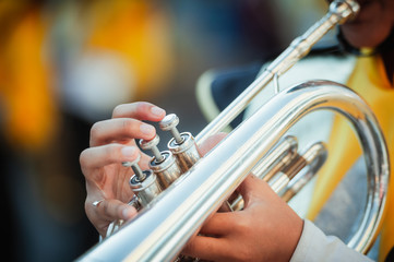 Little boy is playing the trumpet