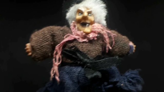 A terrible face of an old witch. Close-up doll toy.