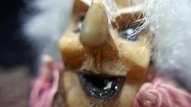 A terrible face of an old witch. Macro close-up doll toy.