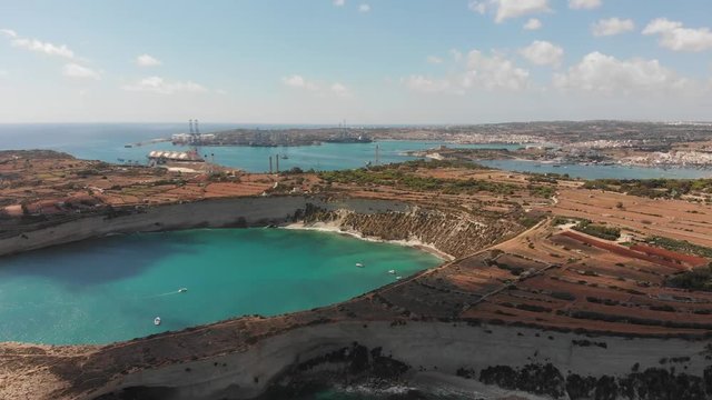 Aerial drone video from eastern Malta, Marsaxlokk area, Il-Hofra l-Kbira bay.