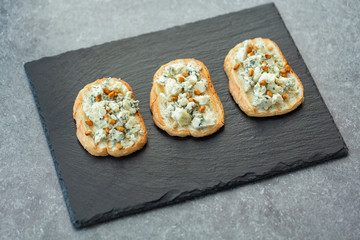 Sandwich, grilled baguette with blue cheese, honey and pine nuts