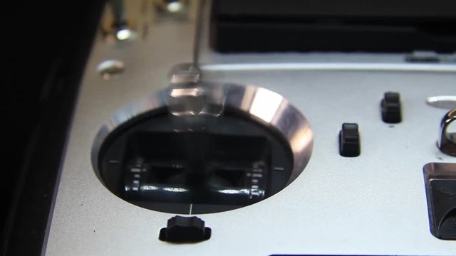 Finger Moving Joystick on a Drone Remote Controller. Close Up.