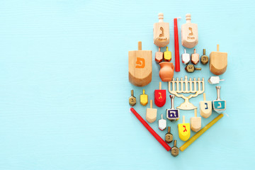 Top view image of jewish holiday Hanukkah background with traditional spinnig top, menorah (traditional candelabra) and candles. © tomertu