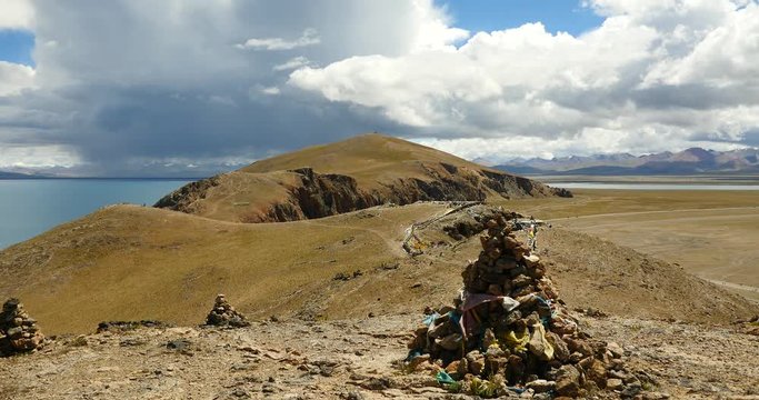 4k huge dark clouds mass rolling over lake namtso & mountain peak,Buddhism mani prayer Stone,tibet mansarovar,Tibet's second largest lake,is the third largest saltwater lake in China.