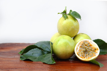 Passion fruit on wooden table with white background. Healthy Fruit on a Wood Table with green leaf.