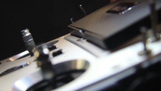 Male Turns On The Drone Remote Controller. Close Up.